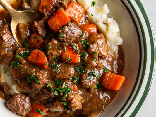 Sous vide beef bourguignon with slow-cooked beef, red wine sauce, bacon, mushrooms, and herbs.