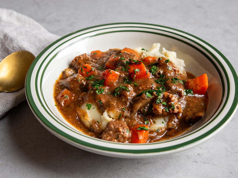 Sous vide beef bourguignon with slow-cooked beef, red wine sauce, bacon, mushrooms, and herbs.