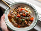 Sous vide beef bourguignon with slow-cooked beef, red wine sauce, bacon, mushrooms, and herbs.